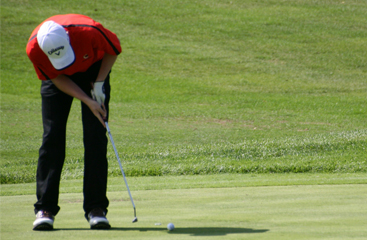 man putting a ball on a golf course