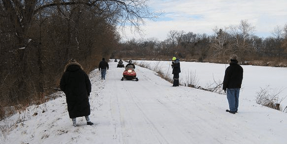 people on snowmobiles