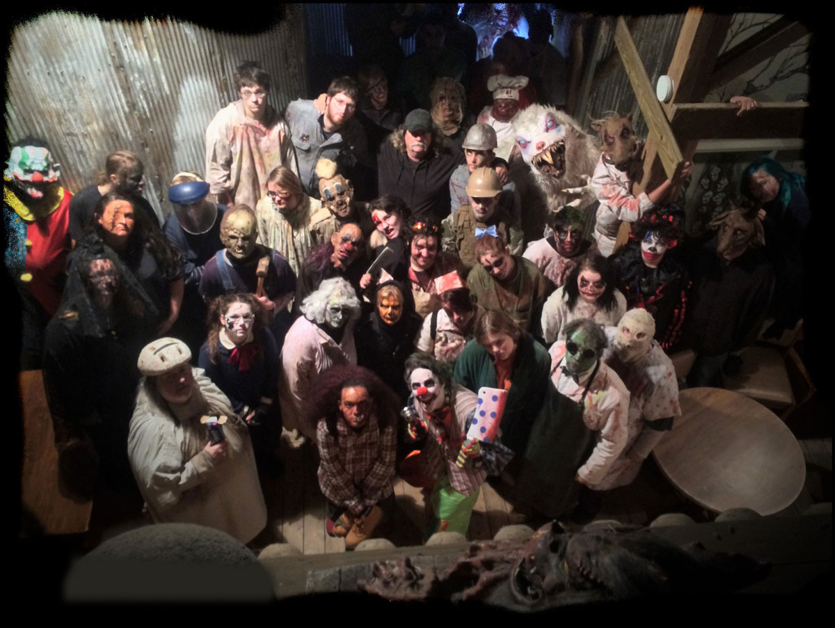 cast of a musical posing for a picture on stage